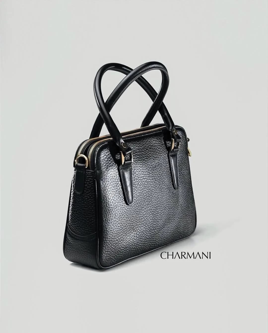 کیف چرمی زنانه مدل لیا Charmani، رنگ مشکی و طلایی، دستی کوچک، زیپدار