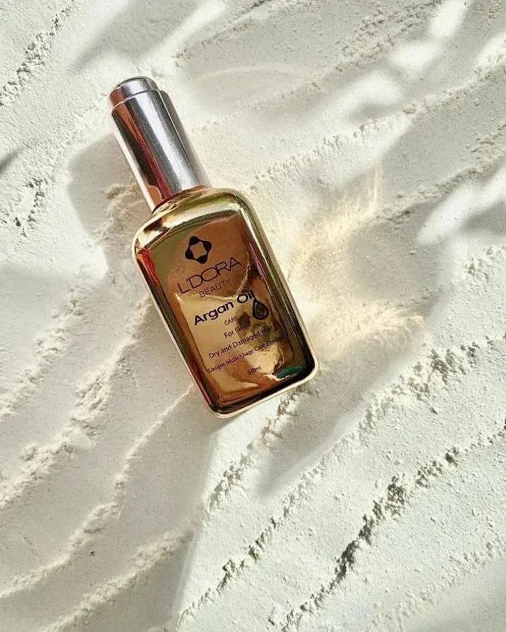 روغن آرگان لدورا، رنگ طلایی و نقرهای، جنس شیشه، بطری قطرهچکان