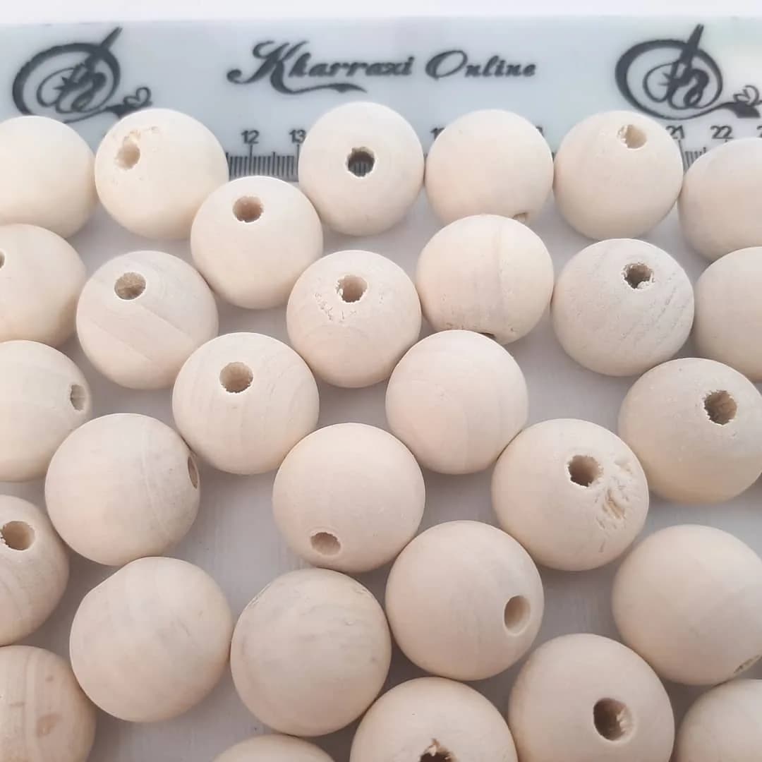 پک ۲۰ عددی مهره چوبی ۲۴ میل — رنگ کرم — نمای دردست — ۲۰ عددی