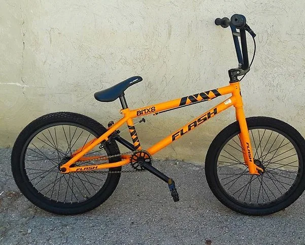 دوچرخه بی‌ام‌ایکس مدل BMX8 فلش، رنگ نارنجی و مشکی، جنس فلز، پلاستیک و لاستیک، دوچرخه کوهستان بی‌ام‌ایکس