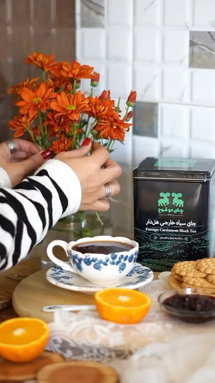 چای سیاه خارجی هل‌دار دوقوچ، رنگ مشکی و سبز، جنس فلز، قوطی استوانه‌ای