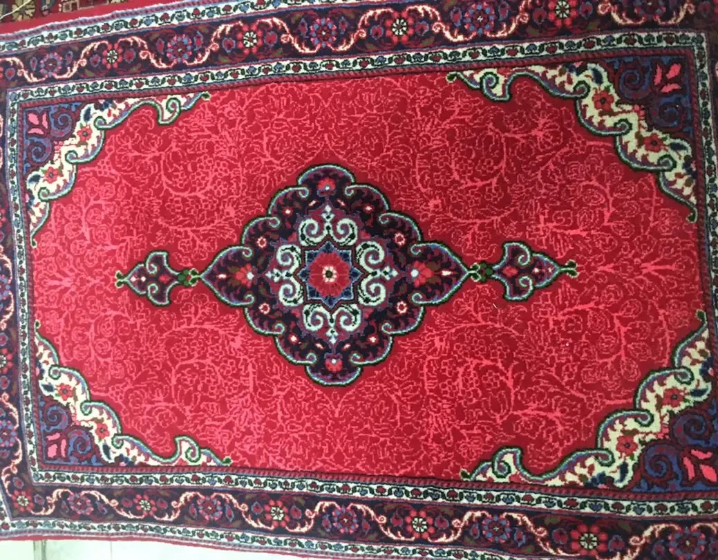 فرش دستباف جوزان، رنگ قرمز، سرمه‌ای و آبی، طرح گلدار، مستطیلی، ترنج‌دار