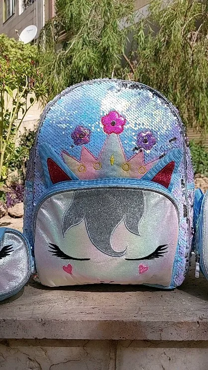 ست کوله مدرسه سه تیکه، رنگ آبی روشن، صورتی و نقره‌ای، جنس پولک‌دوزی و پارچه براق، طرح طرح حیوانی، تاج‌دار با طرح تک‌شاخ