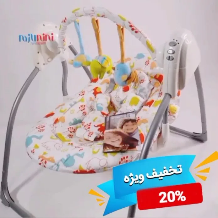 تاب نوزاد ایون فلو، رنگ سفید و خاکستری، جنس فلز و پارچه، طرح گلدار، تاشو، موزیکال