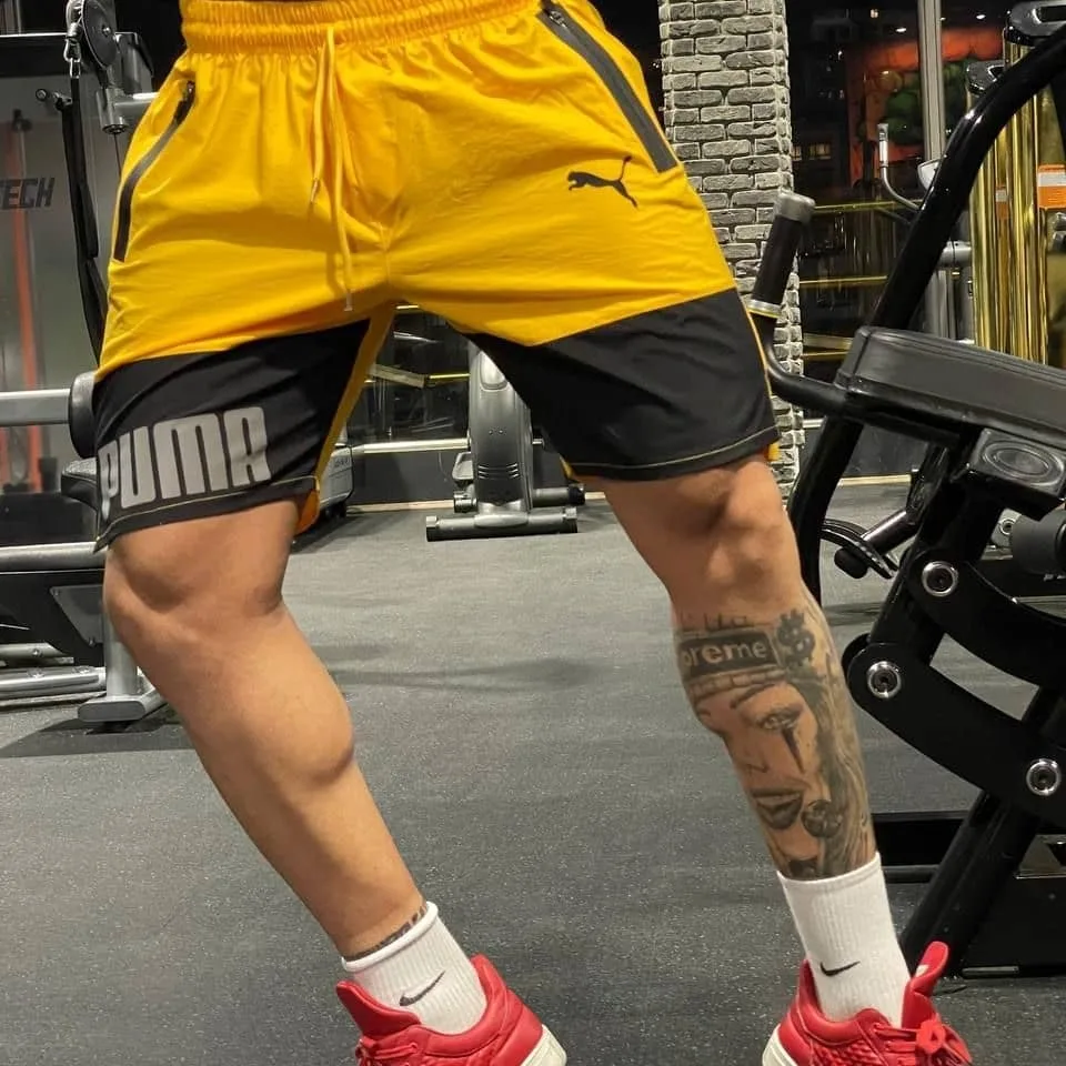 شلوارک ورزشی حرفه‌ای کتان Puma، رنگ زرد و مشکی، کوتاه، بنددار، جذب