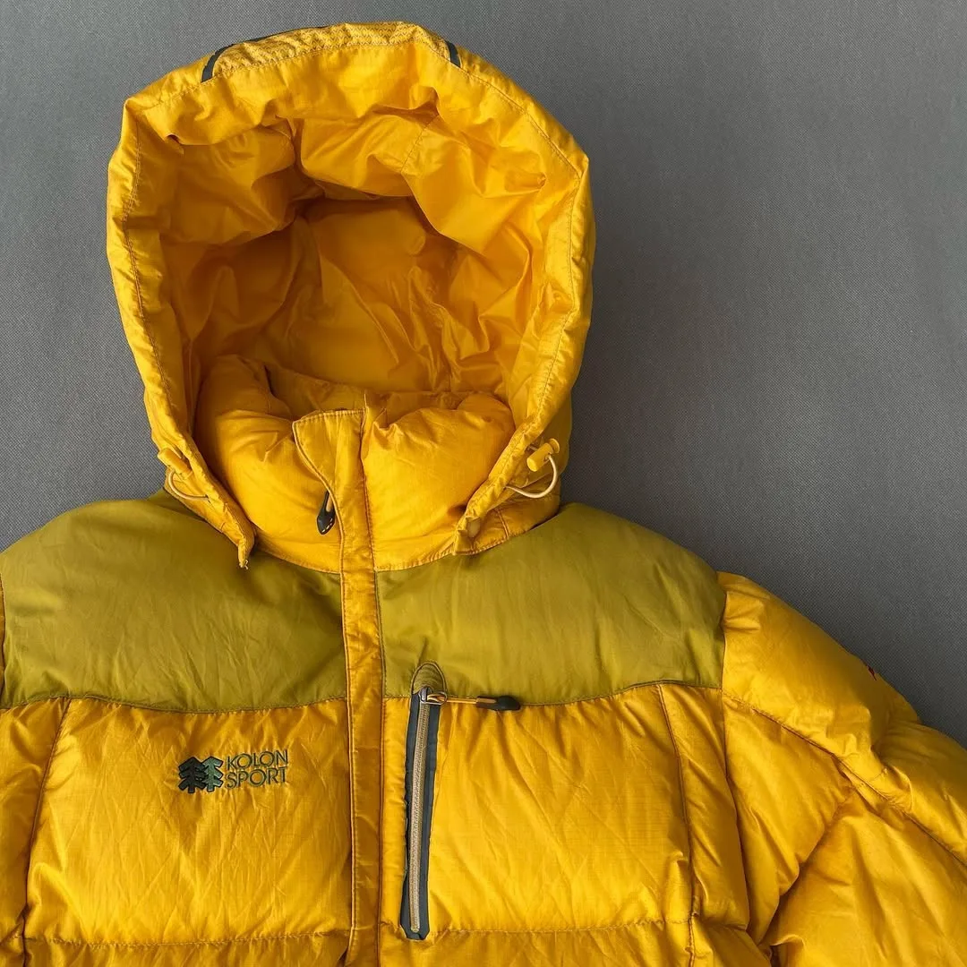 کاپشن پارچه وینداستاپر Kolon Sport، رنگ زرد، کلاهدار، پافر
